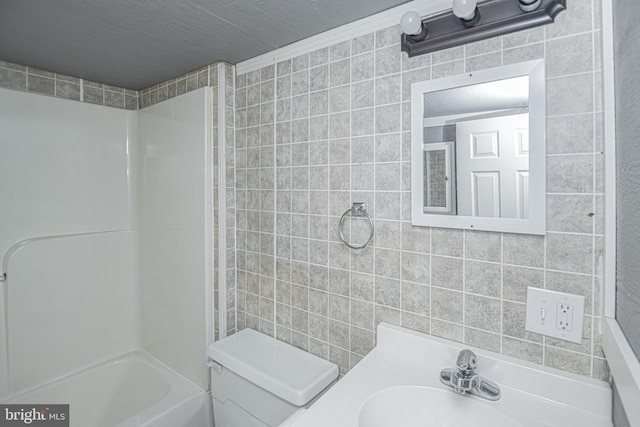 116 N 8th St Unit 2, Oakland, MD 21550 - bathroom with toilet, tile walls, a sink, and washtub / shower combination