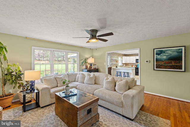 260 High Banks Rd, Stephenson, VA 22656 - living area with a textured ceiling, light wood-style floors, a ceiling fan, and baseboards
