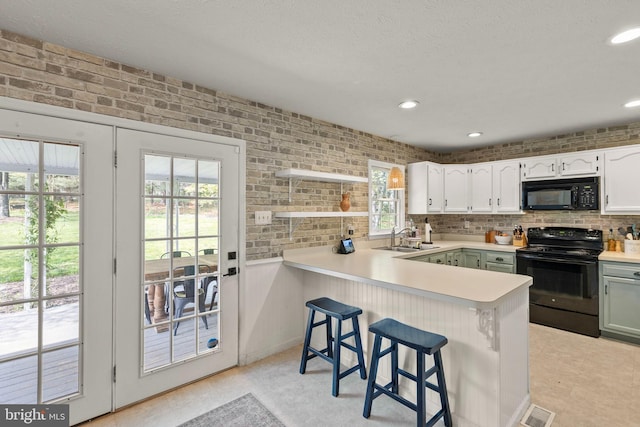 260 High Banks Rd, Stephenson, VA 22656 - kitchen featuring black appliances, light countertops, a peninsula, and a healthy amount of sunlight