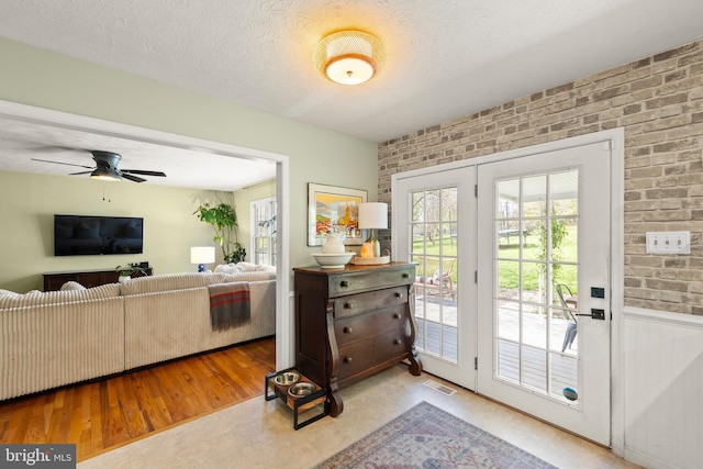 260 High Banks Rd, Stephenson, VA 22656 - entryway featuring a textured ceiling, visible vents, brick wall, wood finished floors, and a ceiling fan