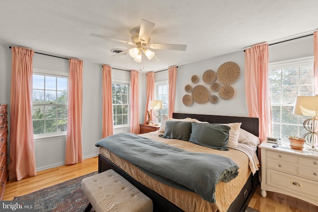 260 High Banks Rd, Stephenson, VA 22656 - bedroom featuring a ceiling fan, light wood-style flooring, baseboards, and multiple windows