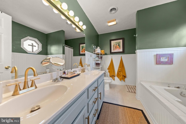 260 High Banks Rd, Stephenson, VA 22656 - full bathroom with a tub to relax in, a wainscoted wall, toilet, and a sink