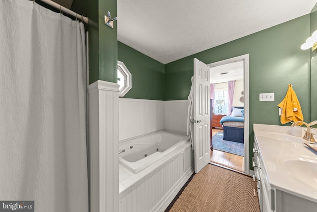 260 High Banks Rd, Stephenson, VA 22656 - bathroom featuring a whirlpool tub, double vanity, a sink, and wainscoting