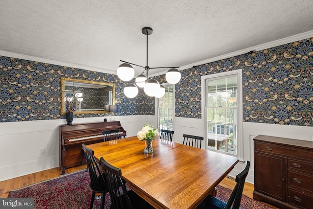 260 High Banks Rd, Stephenson, VA 22656 - dining area with wainscoting, ornamental molding, wood finished floors, and wallpapered walls