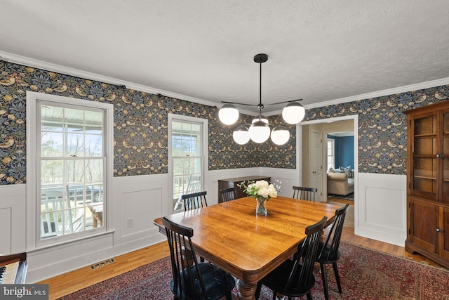 260 High Banks Rd, Stephenson, VA 22656 - dining area featuring crown molding, visible vents, a chandelier, wood finished floors, and wainscoting