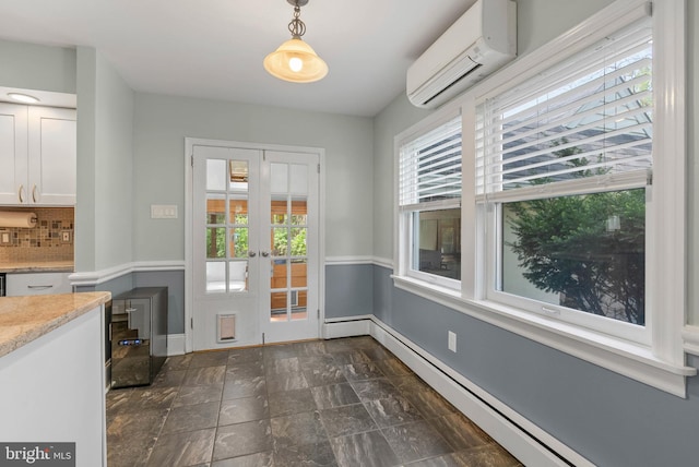 doorway to outside featuring baseboard heating, baseboards, a healthy amount of sunlight, and an AC wall unit