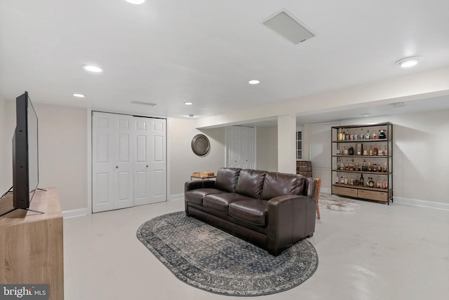 living area featuring recessed lighting and baseboards