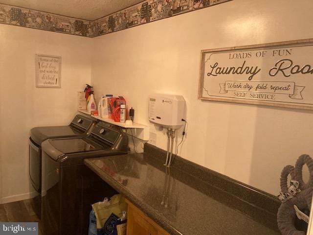 washroom with washer and dryer, laundry area, and baseboards
