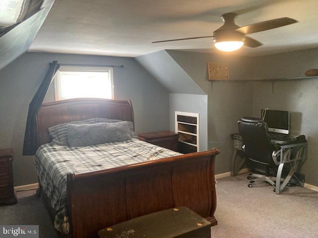 bedroom with baseboards, carpet, ceiling fan, and vaulted ceiling