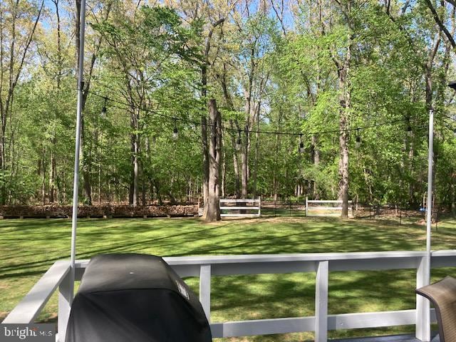 view of property's community featuring fence and a yard