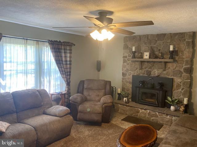 living room with a ceiling fan and a textured ceiling