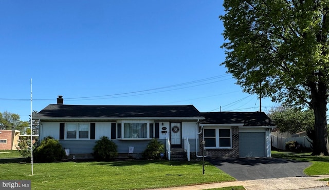 single story home featuring aphalt driveway, fence, a front yard, brick siding, and an attached garage