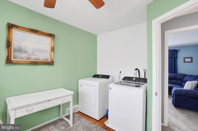 clothes washing area with laundry area, a ceiling fan, independent washer and dryer, and wood finished floors