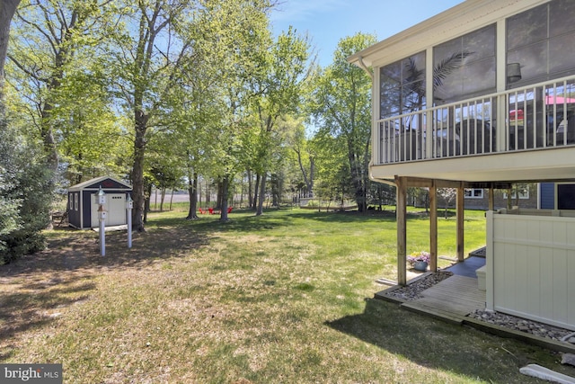 view of yard featuring a storage unit, an outdoor structure, and a sunroom