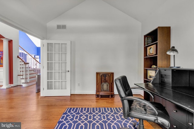 office with baseboards, ornate columns, wood finished floors, and visible vents