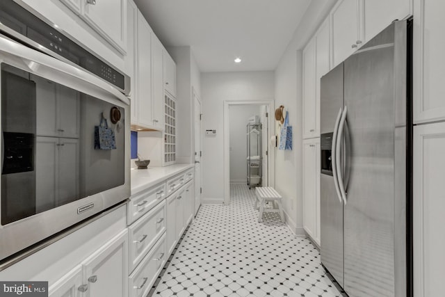 kitchen with light countertops, appliances with stainless steel finishes, white cabinets, and recessed lighting