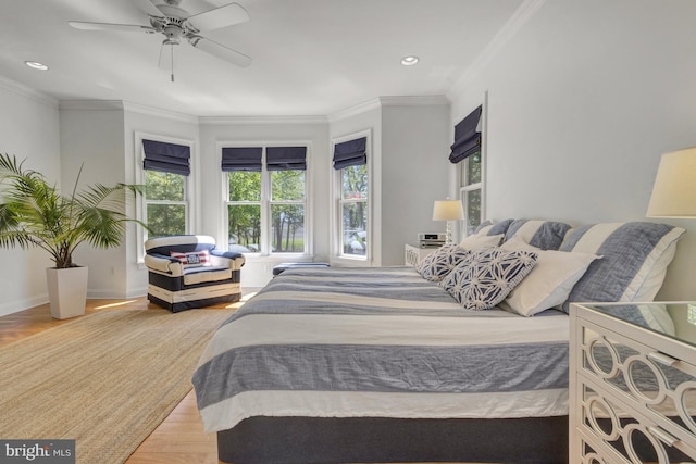 bedroom with baseboards, ornamental molding, recessed lighting, and wood finished floors