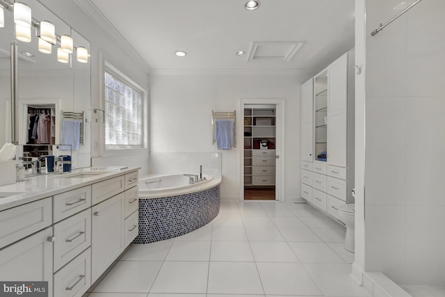 full bathroom with a bath, crown molding, vanity, toilet, and a spacious closet