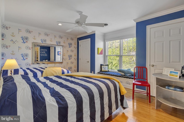 bedroom with light wood-style flooring, recessed lighting, wallpapered walls, ornamental molding, and a closet