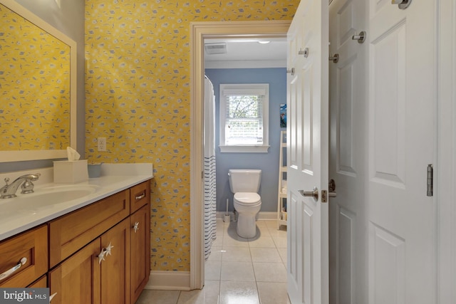 bathroom with toilet, tile patterned floors, baseboards, and vanity