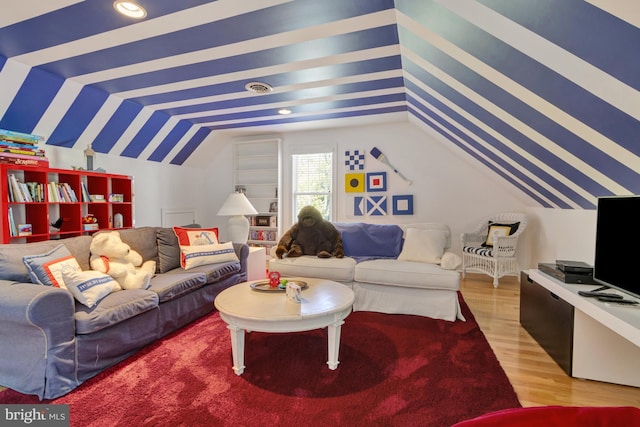 living room featuring light wood finished floors and lofted ceiling