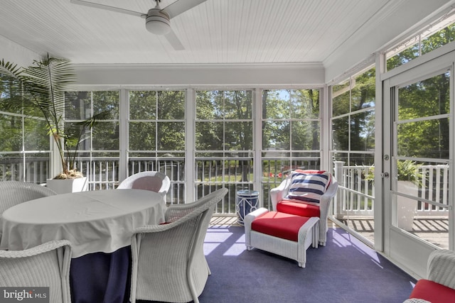 sunroom featuring ceiling fan, french doors, and a wealth of natural light
