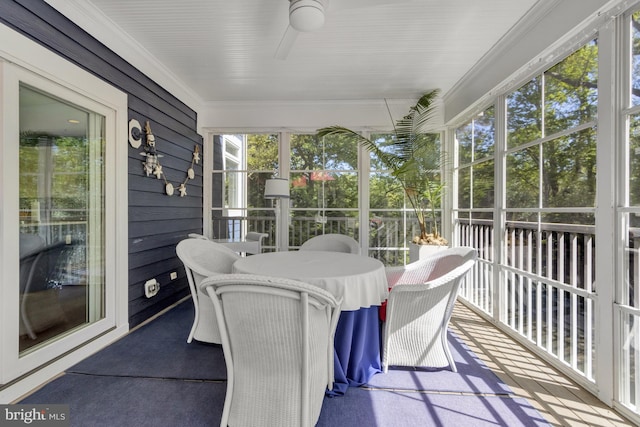 sunroom featuring ceiling fan