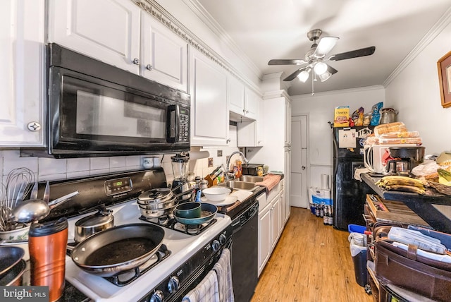 235 Medwick Garth E, Baltimore, MD 21228 - kitchen with a sink, tasteful backsplash, black appliances, light wood-style flooring, and white cabinetry