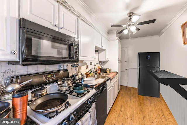 235 Medwick Garth E, Baltimore, MD 21228 - kitchen featuring light wood-style flooring, a sink, white cabinetry, black appliances, and backsplash