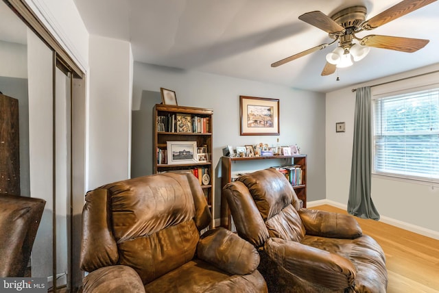 235 Medwick Garth E, Baltimore, MD 21228 - living area featuring baseboards, wood finished floors, and a ceiling fan