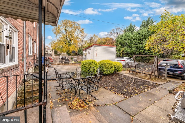235 Medwick Garth E, Baltimore, MD 21228 - view of patio featuring fence and an outbuilding