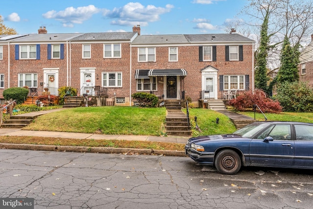 235 Medwick Garth E, Baltimore, MD 21228 - multi unit property featuring a chimney, a front yard, and brick siding