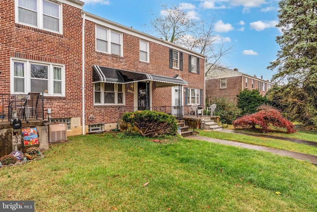 235 Medwick Garth E, Baltimore, MD 21228 - view of front facade with a front yard and brick siding