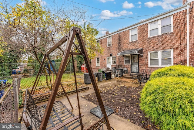 235 Medwick Garth E, Baltimore, MD 21228 - rear view of property with a patio area, brick siding, and fence