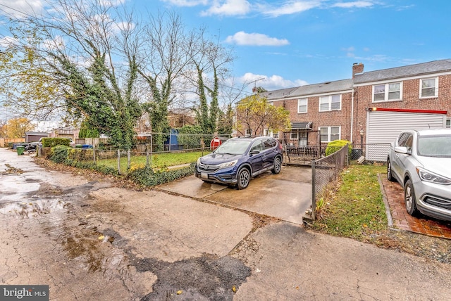 235 Medwick Garth E, Baltimore, MD 21228 - view of front of house with a chimney, brick siding, and fence