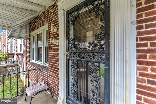 235 Medwick Garth E, Baltimore, MD 21228 - doorway to property featuring a porch and brick siding