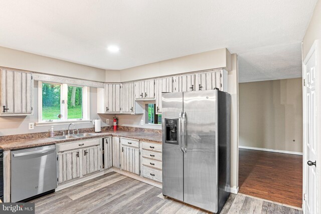 1604 Kathryn St, New Cumberland, PA 17070 - kitchen featuring stainless steel appliances, a sink, light wood-type flooring, baseboards, and light countertops