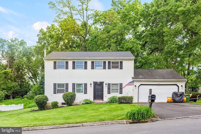 1604 Kathryn St, New Cumberland, PA 17070 - colonial inspired home featuring an attached garage, driveway, a front yard, and view of wooded area