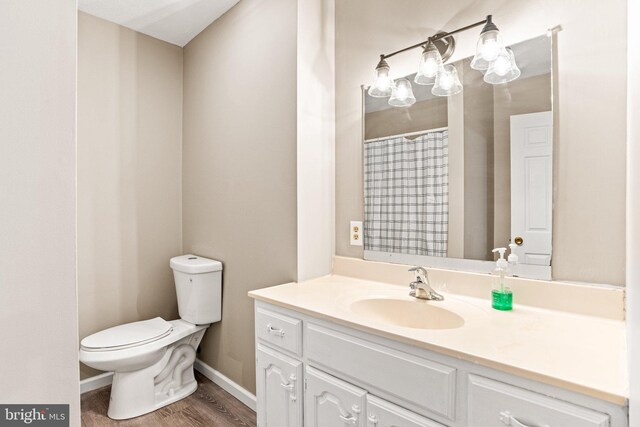 1604 Kathryn St, New Cumberland, PA 17070 - bathroom with toilet, wood finished floors, vanity, baseboards, and a shower with shower curtain