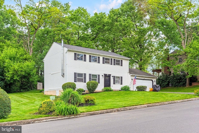 1604 Kathryn St, New Cumberland, PA 17070 - colonial home with an attached garage, a front yard, and view of wooded area