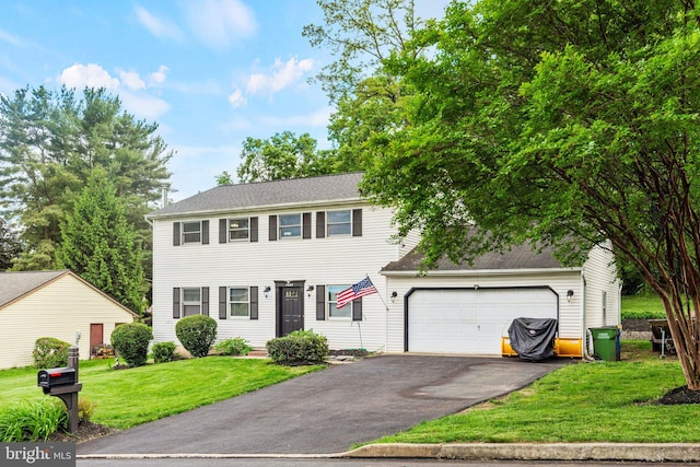 1604 Kathryn St, New Cumberland, PA 17070 - colonial-style house with asphalt driveway, a front yard, and a garage