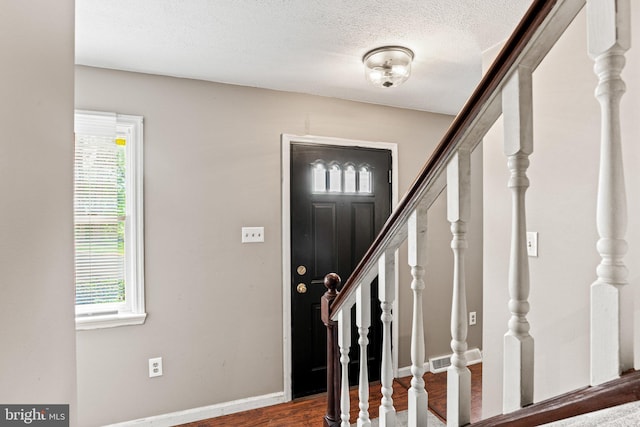 1604 Kathryn St, New Cumberland, PA 17070 - entrance foyer featuring stairs, wood finished floors, a textured ceiling, and baseboards