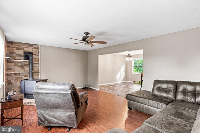 1604 Kathryn St, New Cumberland, PA 17070 - living room featuring a ceiling fan, a wood stove, wood finished floors, and baseboards