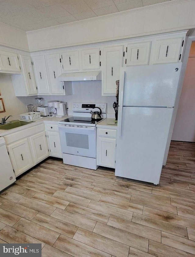 11 91st St Unit 102, Ocean City, MD 21842 - kitchen with white appliances, white cabinets, under cabinet range hood, and light wood-type flooring