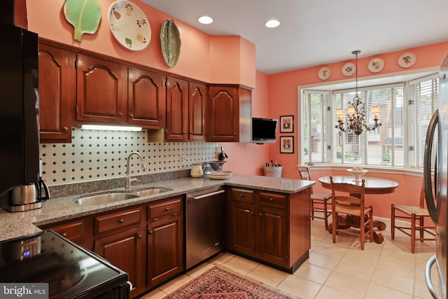 10204 Aspen Willow Dr, Fairfax, VA 22032 - kitchen featuring stainless steel appliances, a sink, a peninsula, hanging light fixtures, and light tile patterned floors