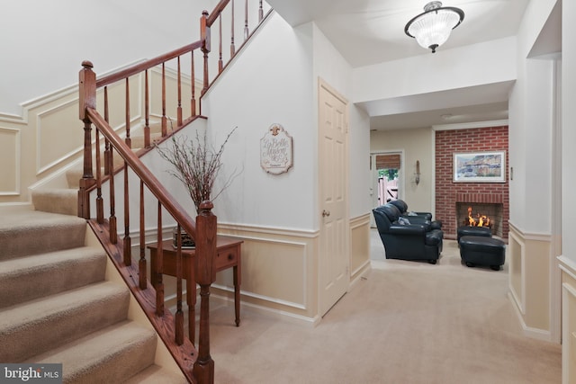 10204 Aspen Willow Dr, Fairfax, VA 22032 - stairs with carpet, wainscoting, a brick fireplace, and a decorative wall