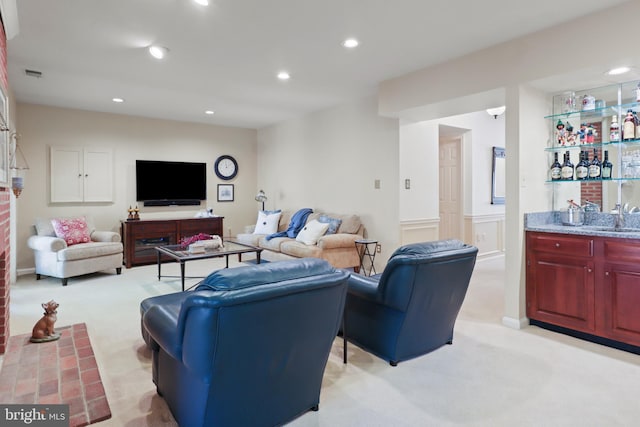 10204 Aspen Willow Dr, Fairfax, VA 22032 - living area featuring light colored carpet, bar with sink, recessed lighting, and a wainscoted wall