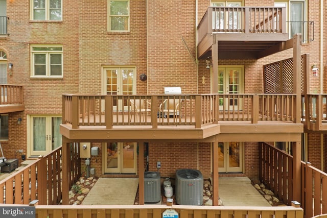 10204 Aspen Willow Dr, Fairfax, VA 22032 - rear view of house featuring brick siding, central AC unit, a balcony, and french doors