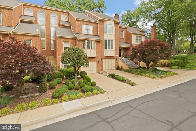 10204 Aspen Willow Dr, Fairfax, VA 22032 - view of front of home with concrete driveway, brick siding, and a garage