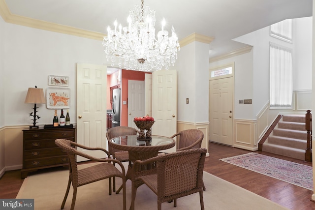 10204 Aspen Willow Dr, Fairfax, VA 22032 - dining space with ornamental molding, wainscoting, wood finished floors, a chandelier, and stairway
